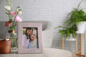 Image of a framed photo of a smiling senior woman and a young girl