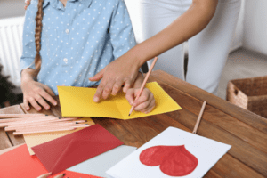 Image of a parent and child making handmade cards