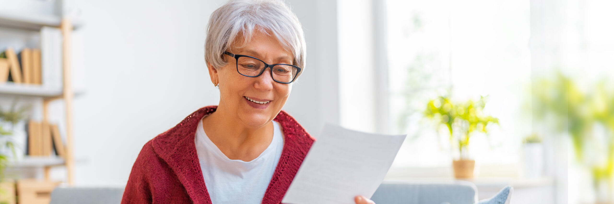 Senior smiling and looking over paperwork